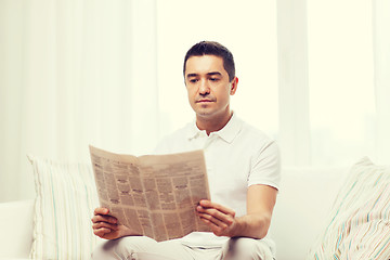 Image showing man reading newspaper at home