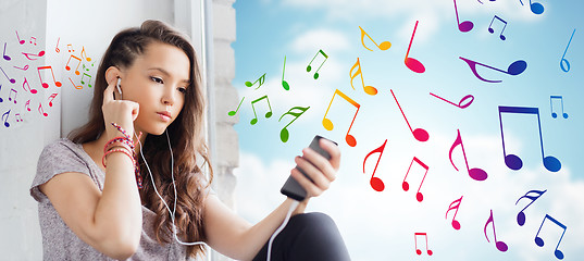 Image showing teenage girl with smartphone and earphones