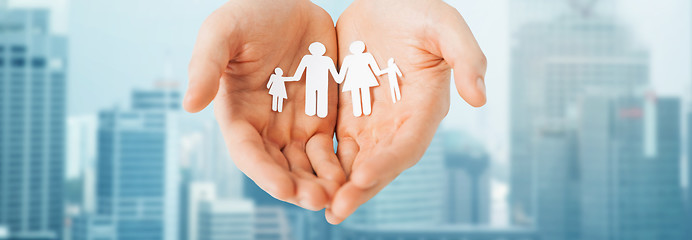 Image showing man hands holding paper cutout of family