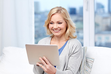 Image showing happy middle aged woman with tablet pc at home