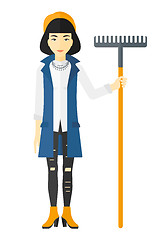 Image showing Woman standing with rake.