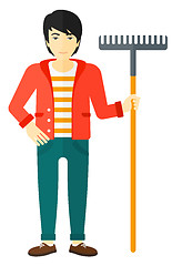 Image showing Man standing with rake.