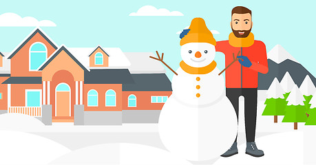 Image showing Man posing near snowman.