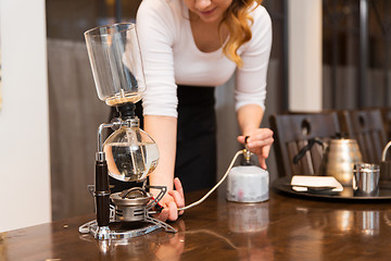 Image showing close up of woman with siphon coffee maker and pot