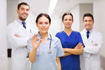 Image showing group of medics at hospital showing ok hand sign