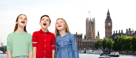 Image showing amazed boy and girls looking up over london