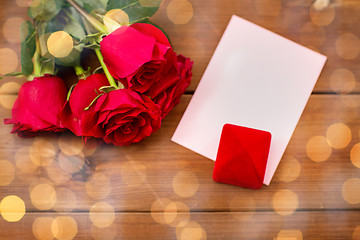 Image showing close up of gift box, red roses and greeting card