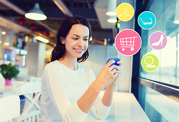 Image showing smiling woman with smartphone shopping online