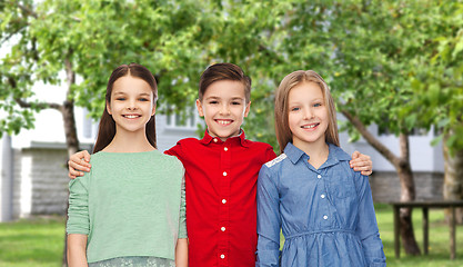 Image showing happy boy and girls hugging over backyard