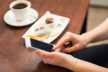 Image showing close up of woman with smartphone and dessert