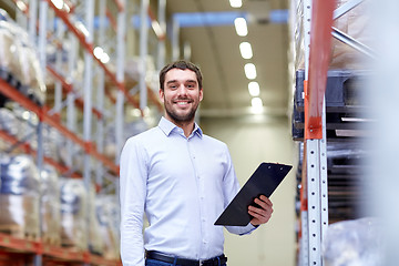 Image showing happy businessman with clipboard at warehouse