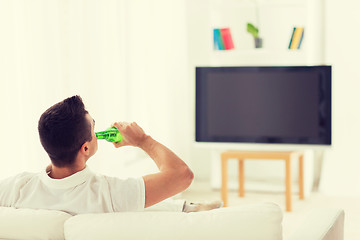 Image showing man watching tv and drinking beer at home