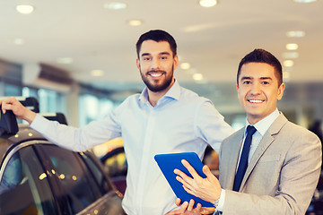 Image showing happy man with car dealer in auto show or salon