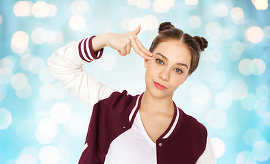 Image showing bored teenage girl making finger gun gesture