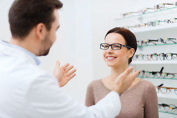 Image showing optician and woman in glasses at optics store