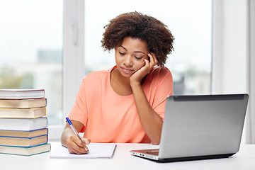 Image showing bored african american woman doing homework home