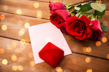 Image showing close up of gift box, red roses and greeting card