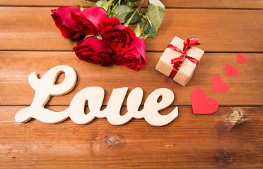 Image showing close up of gift, word love, red roses and hearts