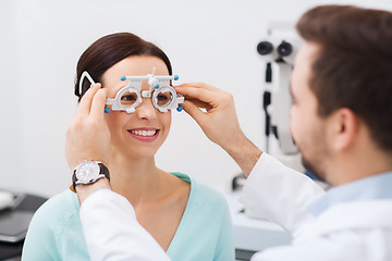 Image showing optician with trial frame and patient at clinic