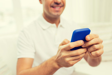 Image showing close up of happy man with smartphone at home