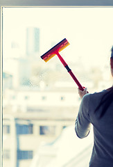 Image showing close up of woman cleaning window with sponge