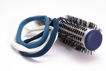 Image showing hairbrush with blue elastic bands