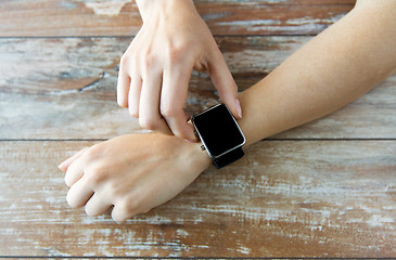 Image showing close up of hands setting smart watch