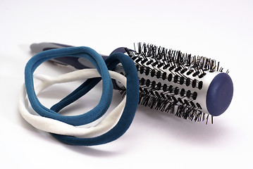 Image showing hairbrush with blue elastic bands