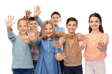 Image showing happy children waving hands