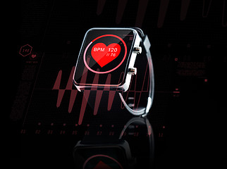 Image showing close up of black smart watch with heart beat icon