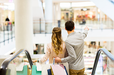 Image showing happy young couple with shopping bags in mall