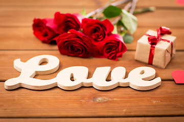 Image showing close up of gift, word love, red roses and hearts