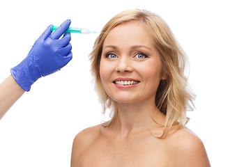Image showing happy woman face and beautician hand with syringe