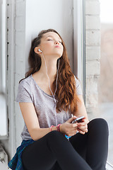 Image showing teenage girl with smartphone and earphones