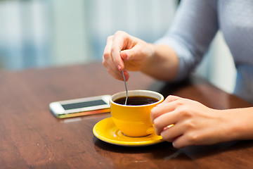 Image showing close up of woman with smartphone and coffee