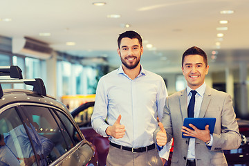 Image showing happy man showing thumbs up in auto show or salon