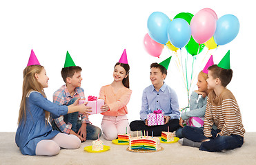 Image showing happy children giving presents at birthday party