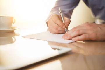 Image showing The male hands with a pen