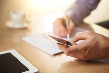 Image showing The male hand holding a phone 