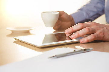 Image showing The male hands with a laptop and the cup