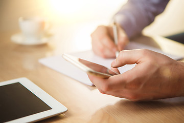 Image showing The male hand holding a phone 