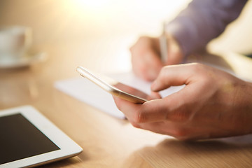 Image showing The male hand holding a phone 