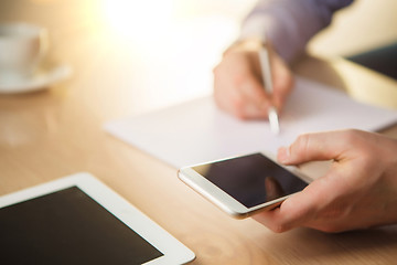 Image showing The male hand holding a phone 