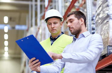 Image showing worker and businessmen with clipboard at warehouse