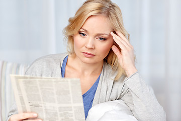 Image showing woman reading newspaper at home