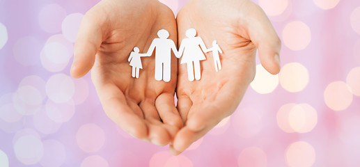 Image showing man hands holding paper cutout of family