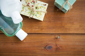 Image showing close up of handmade soap bars and lotions on wood