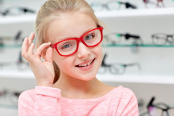 Image showing little girl in glasses at optics store