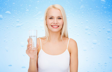 Image showing young smiling woman with glass of water