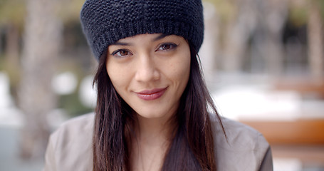 Image showing Pretty thoughtful young woman in a woolly cap